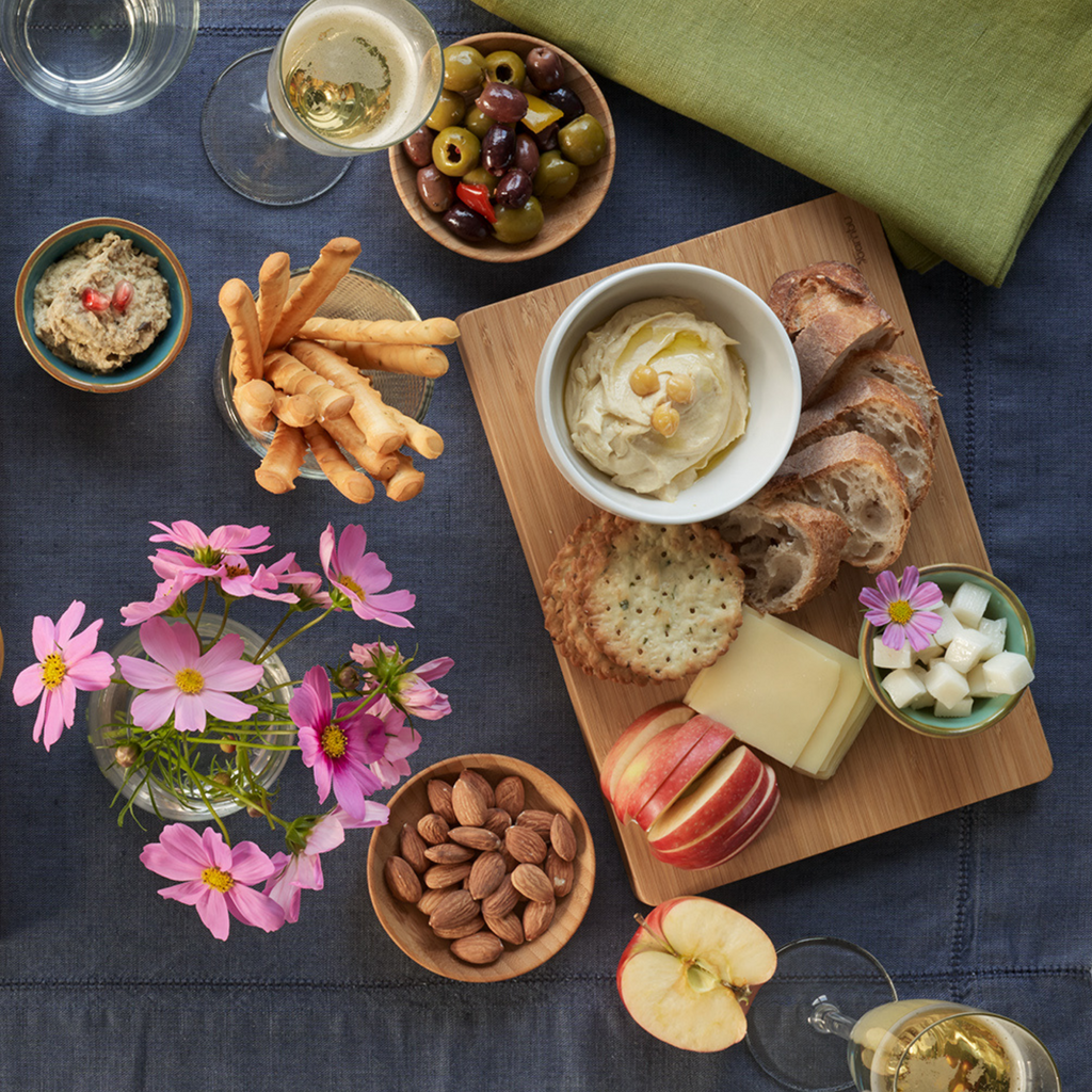 Snack board with brea, cheese, fruit and nuts served up on a medium Undercut Cutting and Serving board.