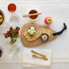 Bamboo Droplet cutting board with crackers and cheese arranged in a swirl.