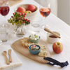 Artisan Droplet Board with crackers and spread. A bamboo honey dipper, spreader, and teaspoon are nearby for serving.