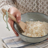 Bamboo rice paddle in a bowl of rice